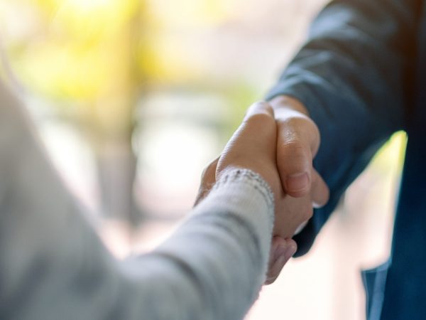 Closeup image of two people shaking hands